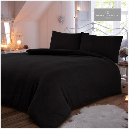 The FLANNEL PLAIN Duvet Cover Set features a luxuriously soft 100% brushed cotton fabric in a timeless black color. This bedding set is breathable and hypoallergenic, perfect for your bed. Its timeless look and elegant design are sure to impress.