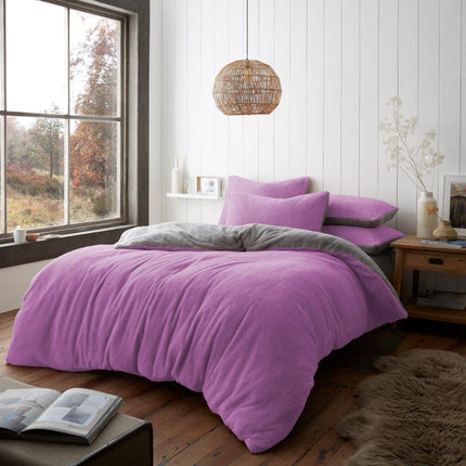 Experience the comfort and style of the REVERSIBLE Duvet Cover Set. This reversible duvet cover set features a teddy style pattern in both a lilac and grey color. Soft and cozy polyester keep you warm all night, and the modern two tone design adds a stylish touch to any bedroom.