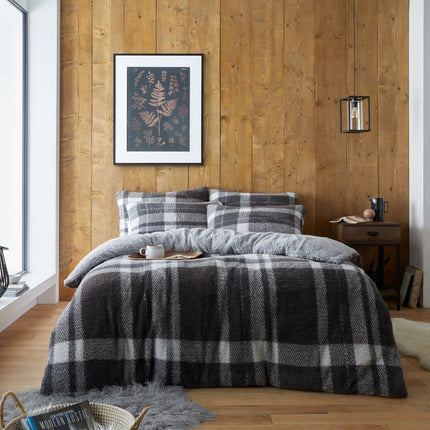 This WINDSOR CHECK Duvet Set features a classic design with a modern twist. Crafted from 100% polyester, the bedding set is soft, breathable, and designed for long lasting comfort. The teddy WINDSOR CHECK pattern is available in grey/charcoal color, offering a timeless neutral look to any bedroom.